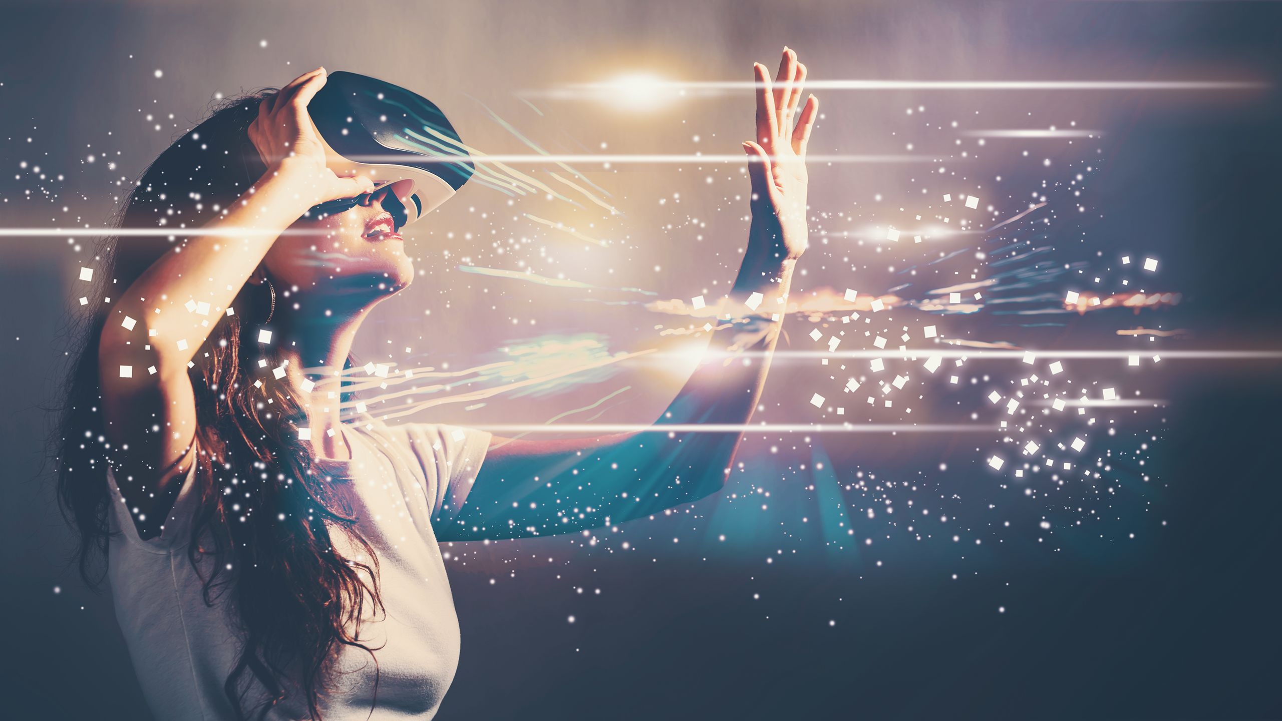 A woman with a VR headset reaching out toward a virtual object symbolising digital transformation