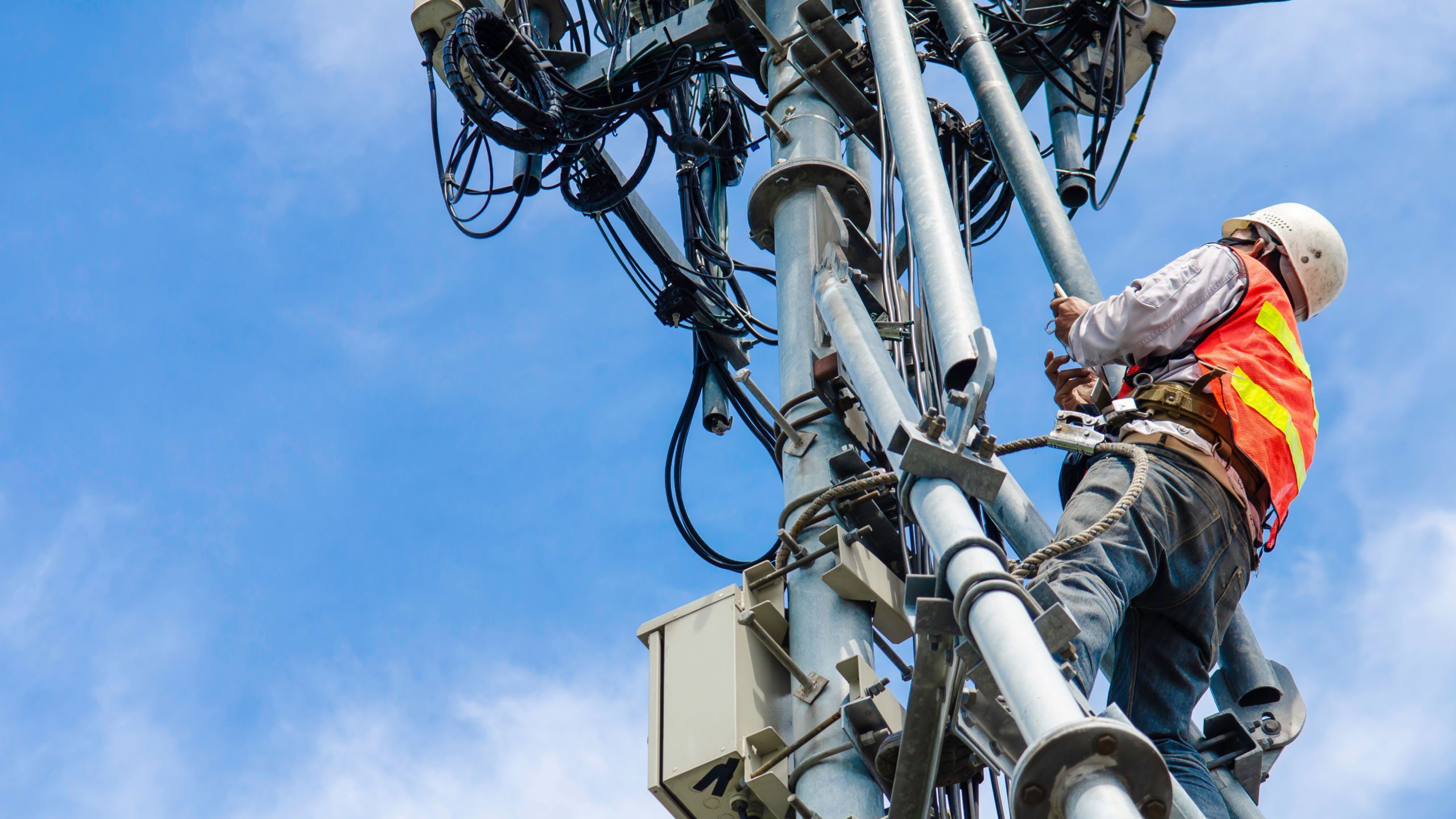 Man climbing a communication tower