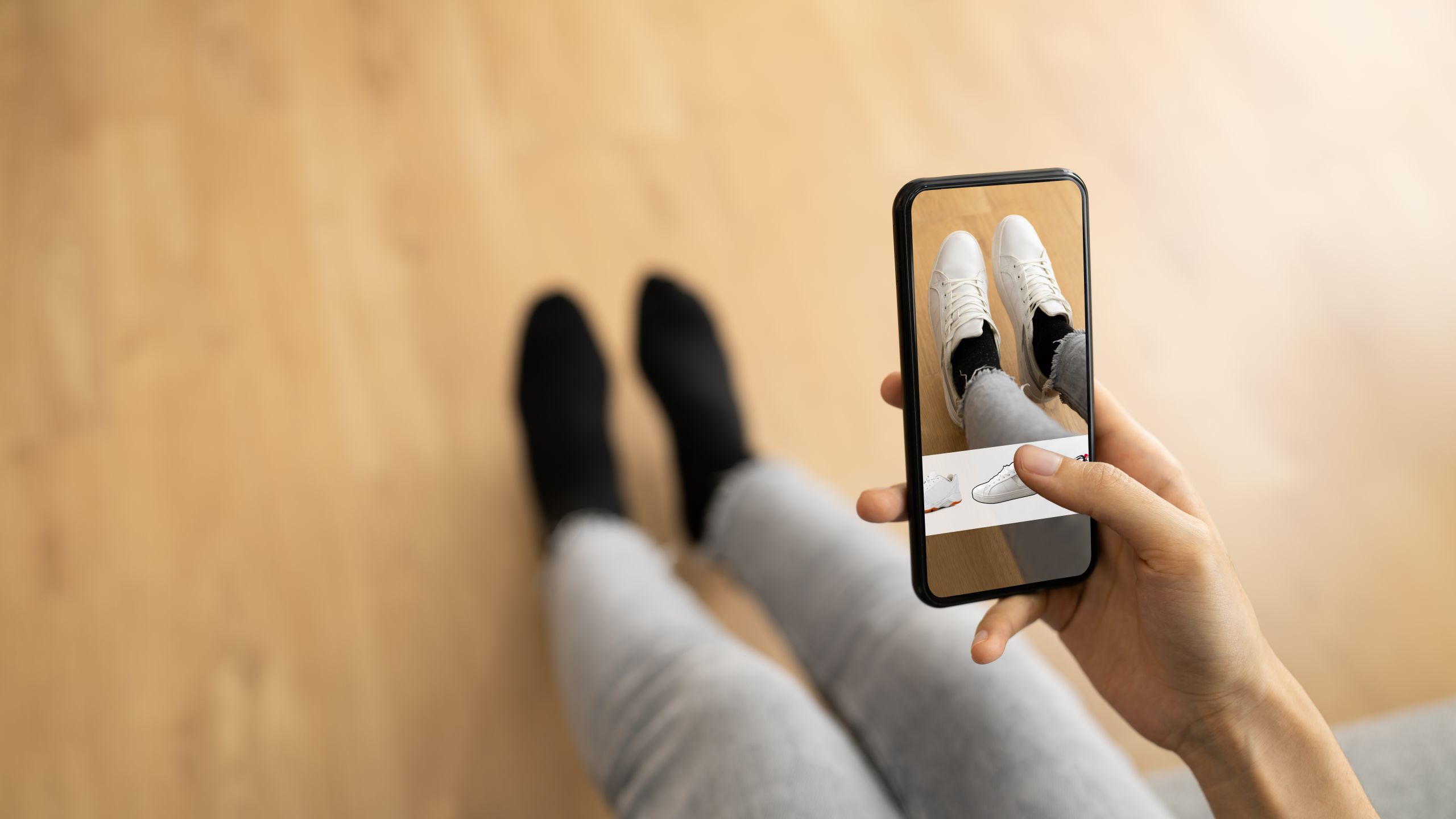 an image of a woman trying on shoes using augmented reality